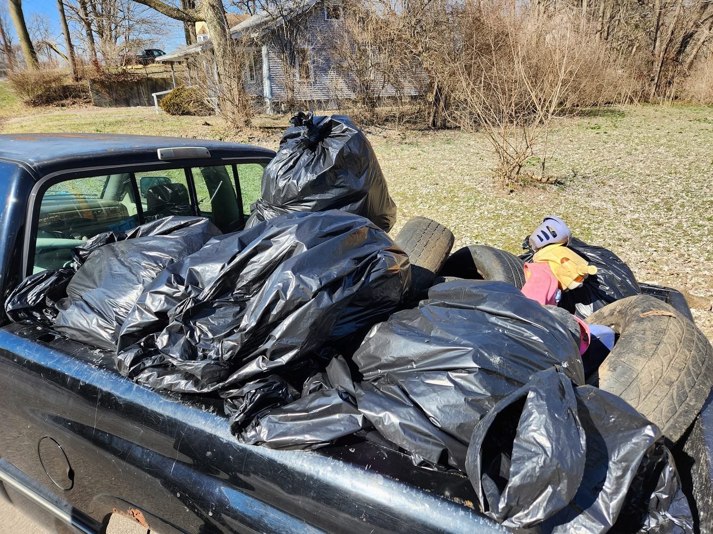 A truck bed full of full bags