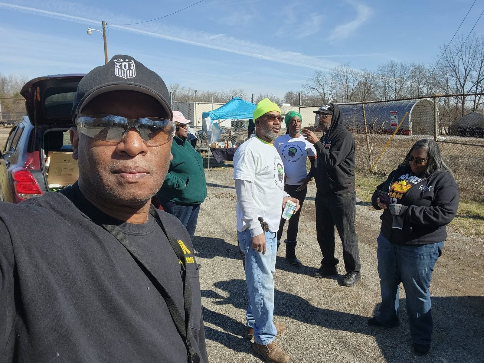 Do Not Be A Litterbug volunteers and partners gathered on a Dayton street at a clean-up